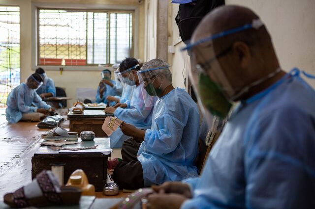 Men resume work with all Covid protection protocols in place at International Footsteps, a footwear manufacturing unit in Dharavi. 10th July 2020.