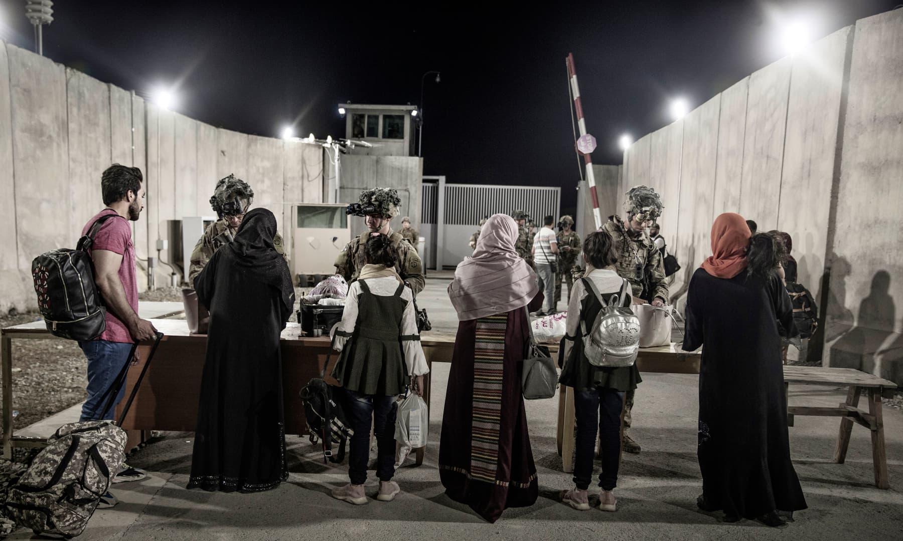 Soldiers with the 82nd Airborne Division check evacuees during an evacuation at Hamid Karzai International Airport in Kabul, Afghanistan on August 25, 2021. — AP