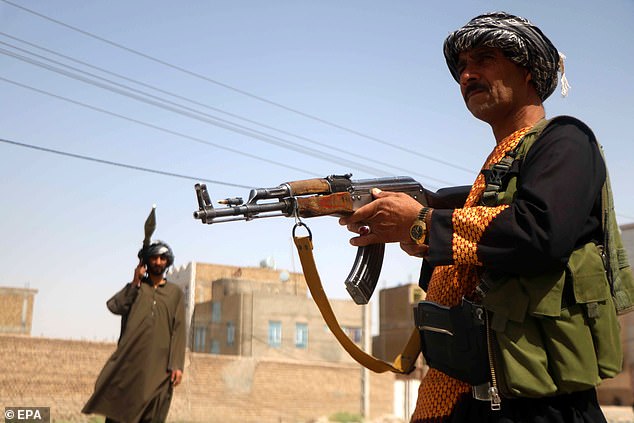 Armed supporters of former Mujahideen commander Ismail Khan, stand guard at a check point in the Pul-e Malan area of Guzara district in Herat, Afghanistan, 30 July 2021