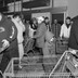 Customers push shopping carts while crowded in a small room.