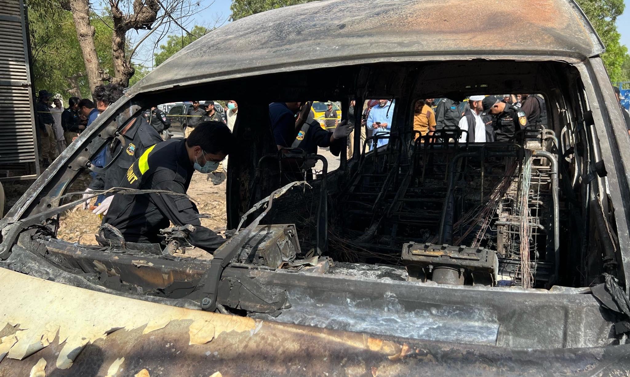 Officials gather evidence from the van. — Photo provided by Shahzeb Ahmed