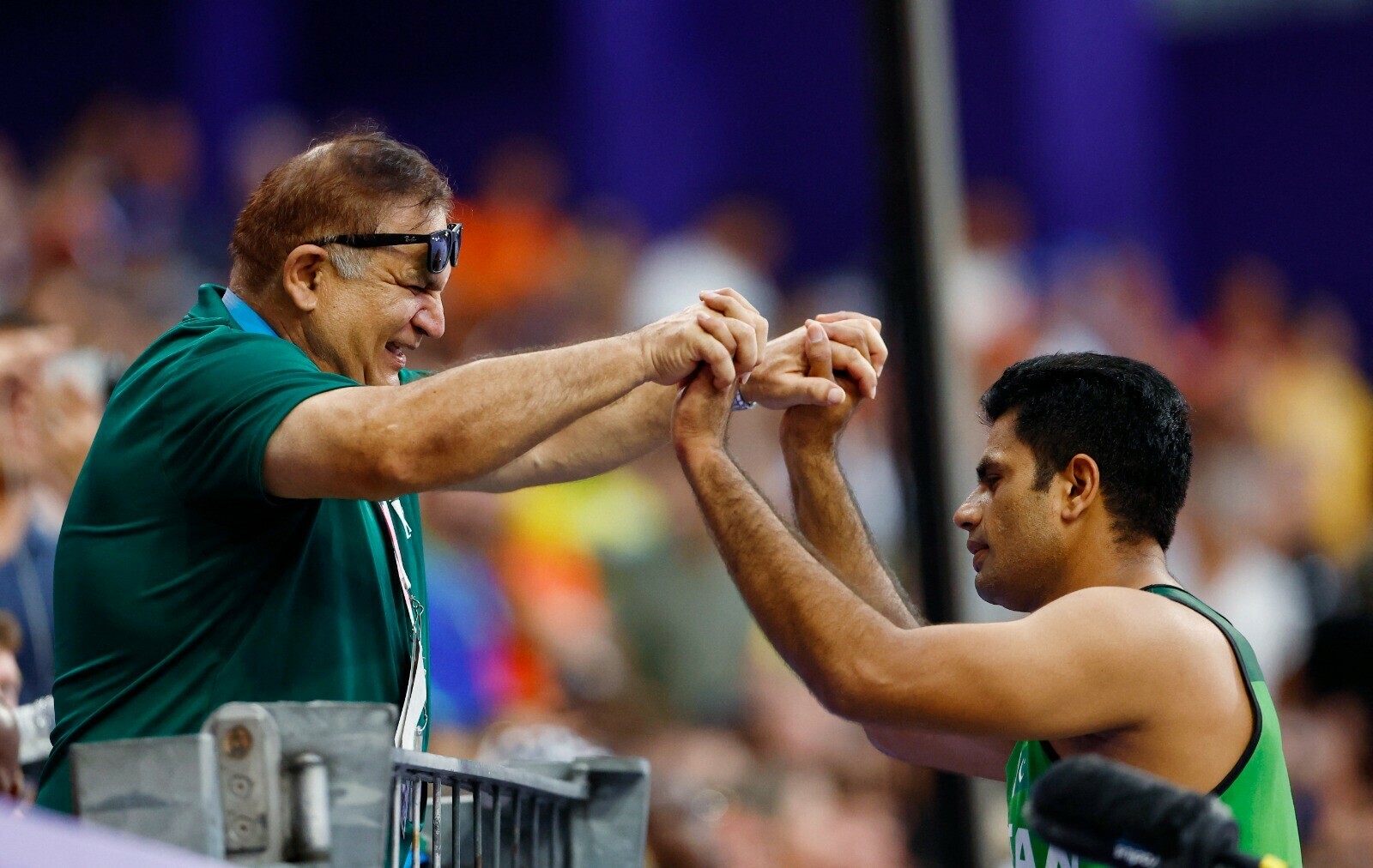 Arshad Nadeem celebrates with coach Salman Butt after throwing an Olympic record on August 8, 2024 at the Stade de France. — Reuters