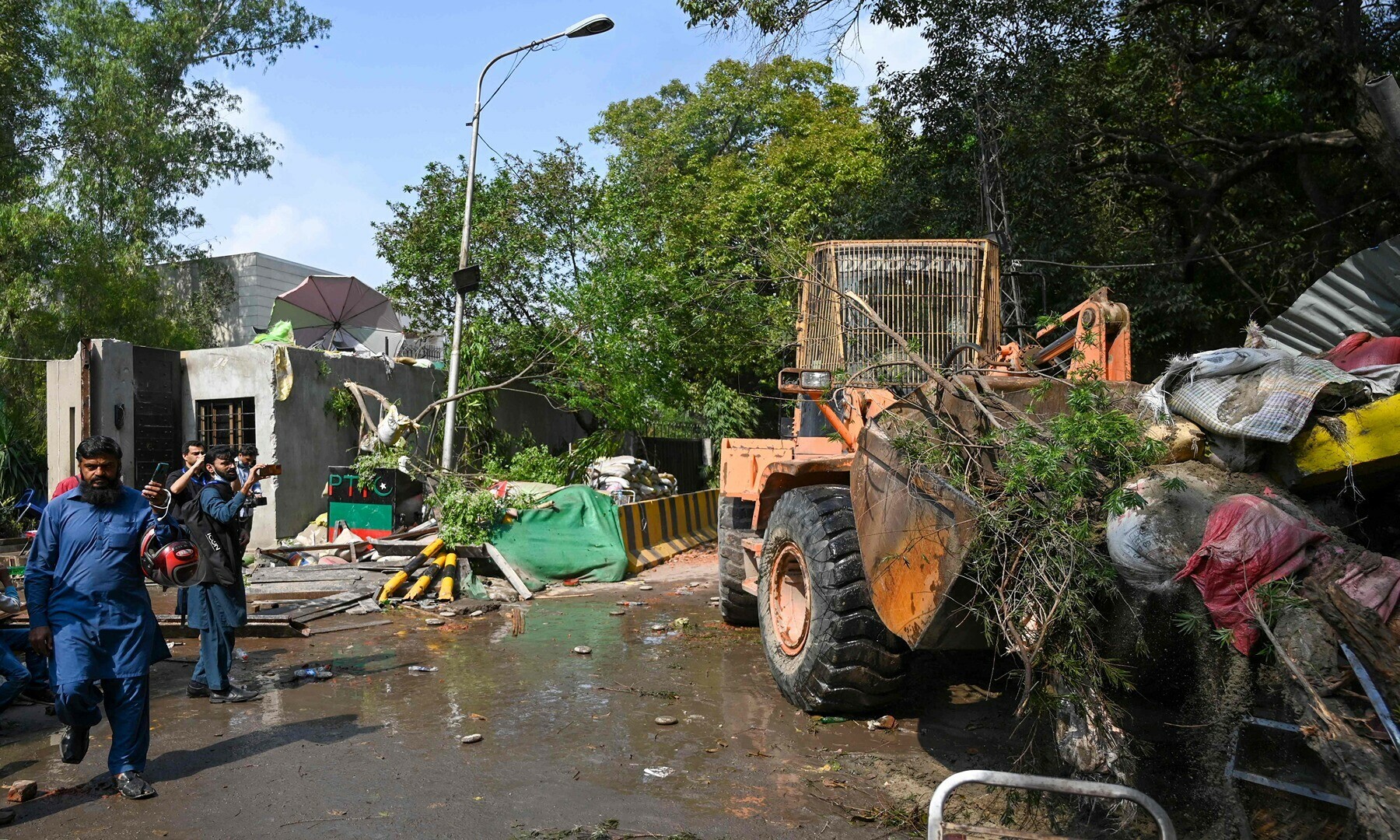 Policemen use heavy machinery to enter Pakistan’s former prime minister Imran Khan’s residence in Lahore on March 18, 2023, after Khan left for Islamabad to appear in a court.— Photo by Arif Ali/AFP