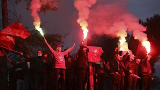 Supporters of the Socialist Movement for Integration (LSI) hold flares during a rally of their party in Tirana, Albania, Thursday, April 22, 2021.