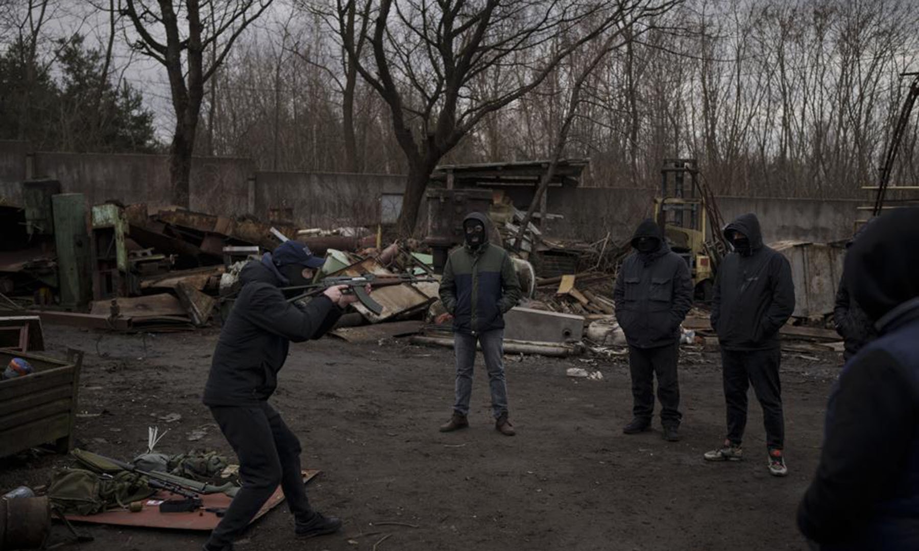 A former Ukrainian soldier gives instructions on how to handle weapons and move during conflict to civilians in the outskirts of Lviv, west Ukraine on Thursday. — AP