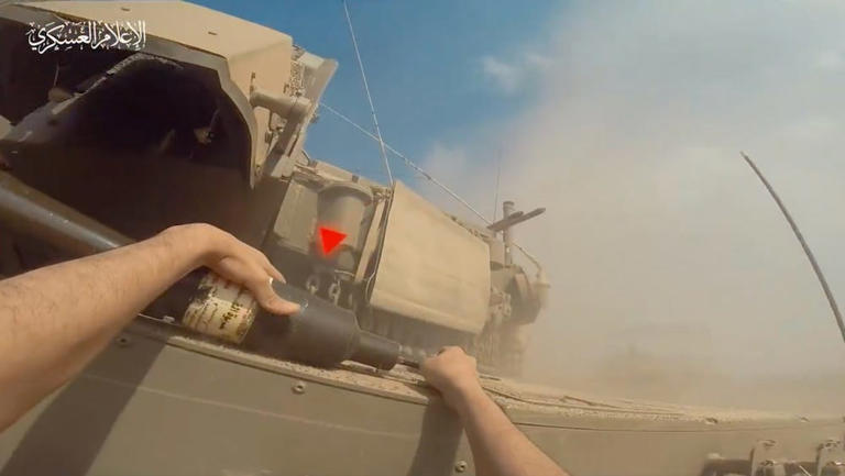 A still from footage released by Hamas' Al-Qassam brigade on November 2 2023, showing the moment a fighter places a device on an Israeli tank. Al-Qassam Brigades/Telegram