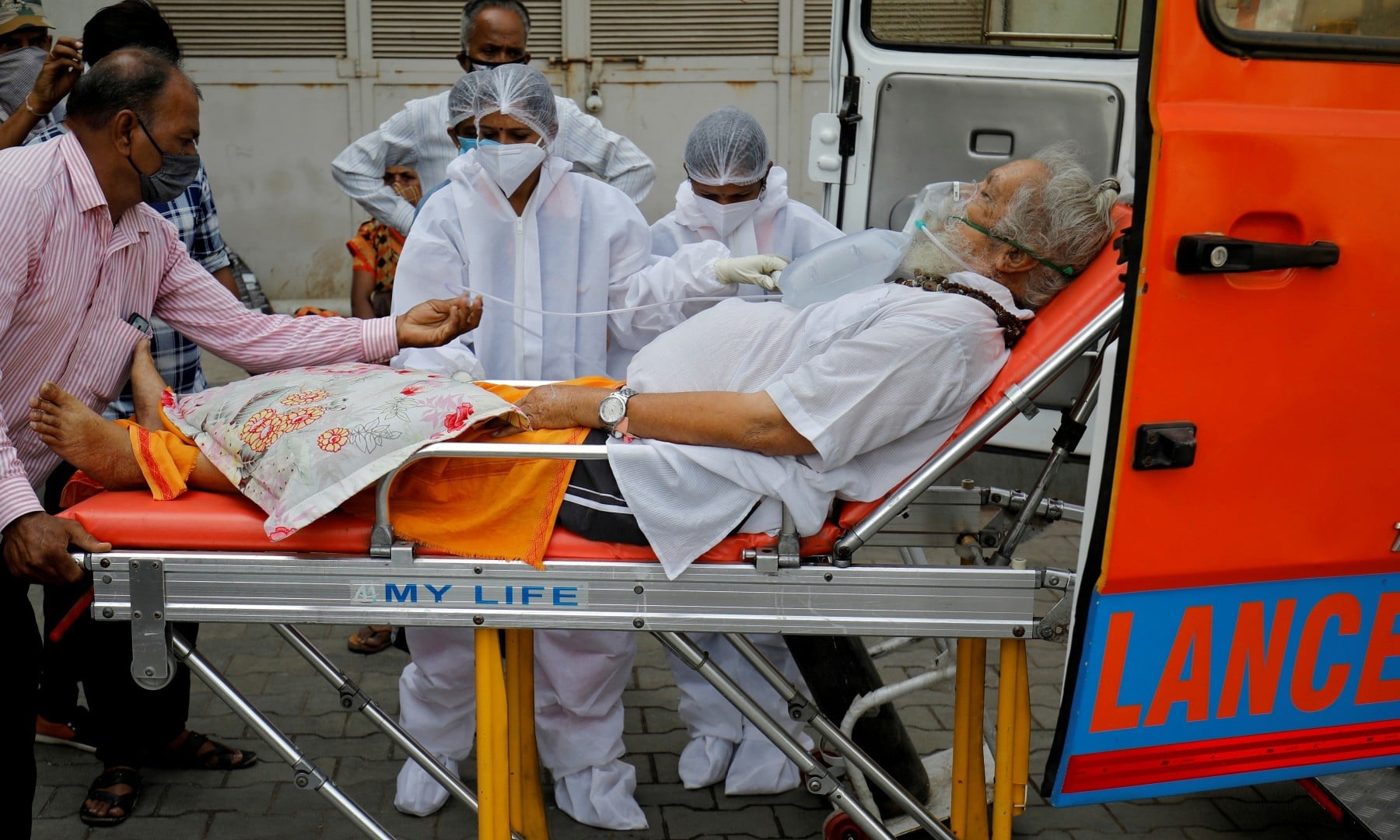 A patient wearing an oxygen mask is wheeled inside a Covid-19 hospital for treatment in Ahmedabad on April 26, 2021. — Reuters