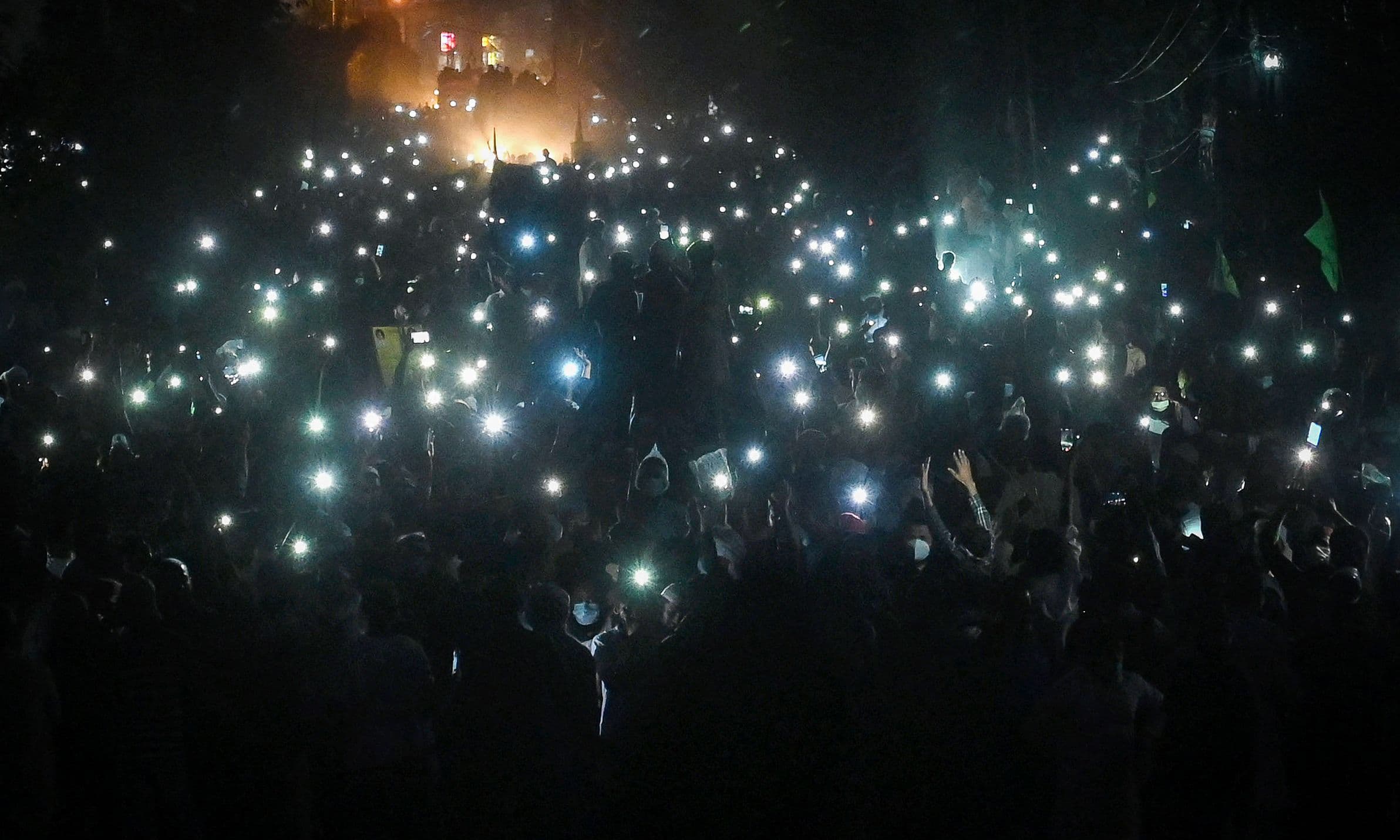 TLP supporters use mobile phone flashlights during a protest march towards Islamabad from Lahore on October 22. — AFP