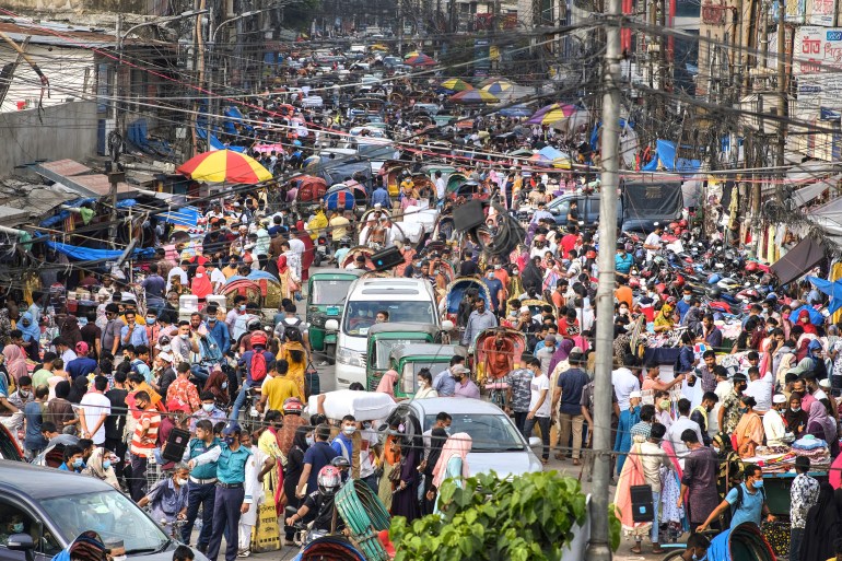 People shop at a market ahead of Eid al-Adha in the capital Dhaka [Mahmud Hossain Opu/AP]