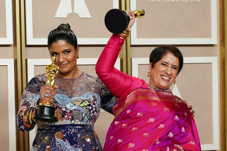 Kartiki Gonsalves, left, and Guneet Monga pose with the award for best documentary short film for The Elephant Whisperer in the press room at the Oscars on Sunday