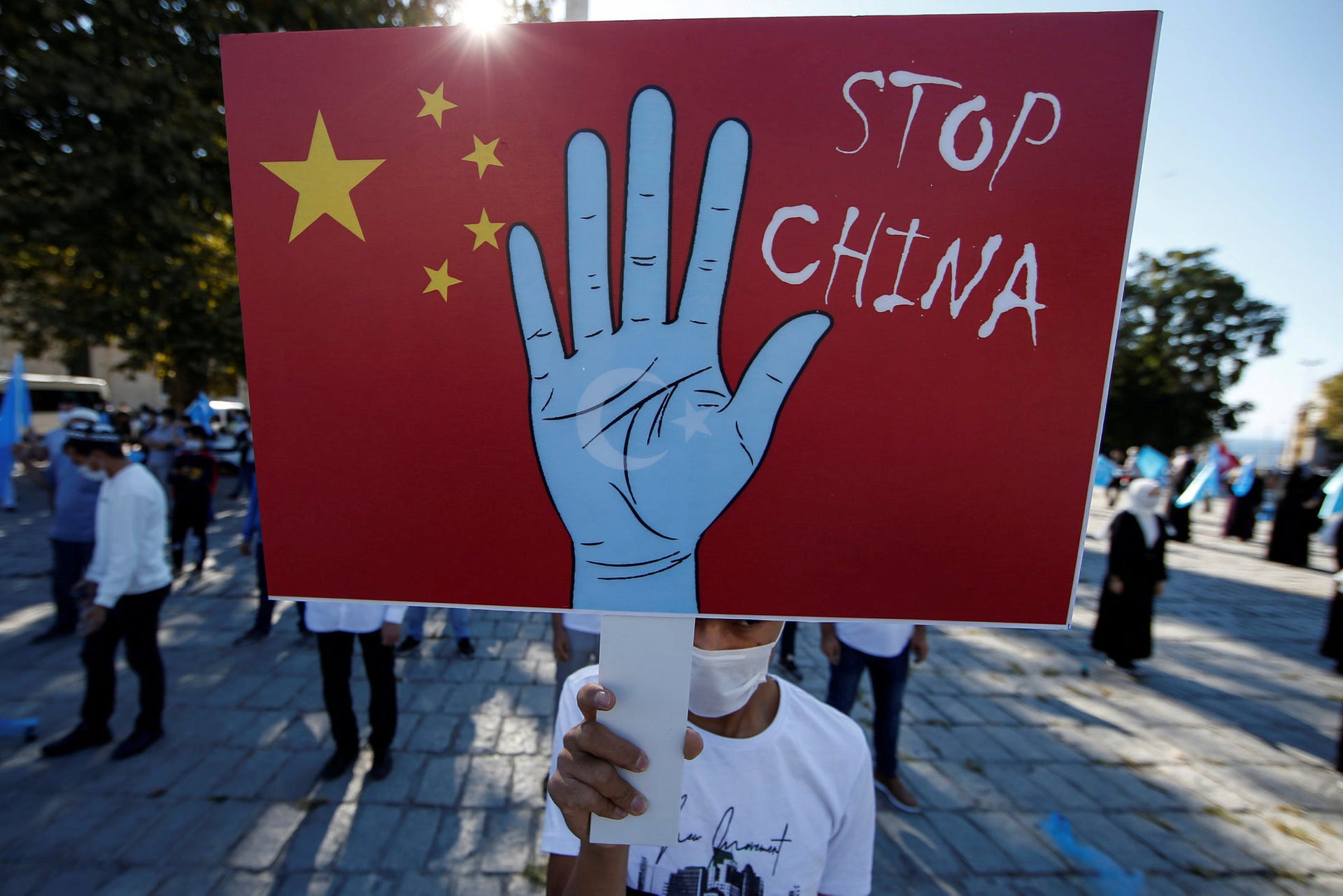 A protester from the Uighur community living in Turkey holding an anti-China placard during a protest in Istanbul, October 1, 2020.