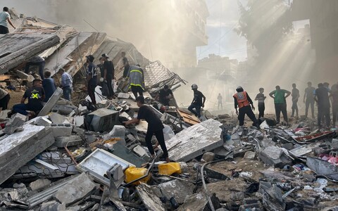 People assess the destruction caused by Israeli air strikes in Gaza City on October 7, 2023.