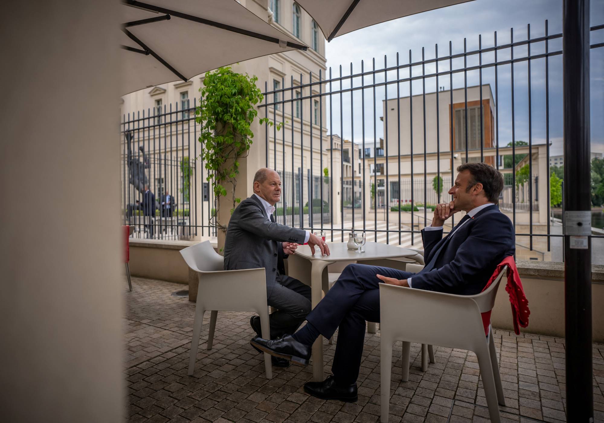 German Chancellor Olaf Scholz talks to French President Emmanuel Macron in Potsdam, Germany, on Tuesday | POOL / VIA REUTERS 