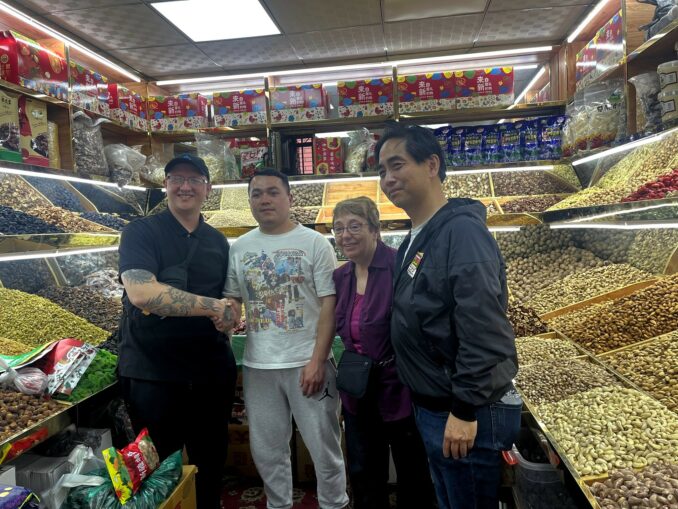 With-dried-fruit-nut-vender-in-Urumqi-678x509.jpeg