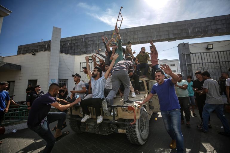 epa10904860 Palestinians ride an Israeli military jeep in the streets of Gaza during the storming of Israeli settlements by militants of the Ezz Al-Din Al Qassam militia, the military wing of Hamas movement, Gaza city, 07 October 2023. Rocket barrages were launched from the Gaza Strip early Saturday in a surprise attack claimed by the Islamist movement Hamas. EPA-EFE/HAITHAM IMAD