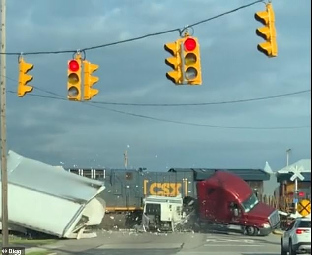 Soon enough, the CSX train plows through the side of the truck, sending the trailer flying