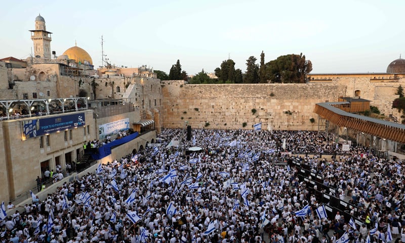 Demonstrators gather with Israeli flags at the Western Wall in the old city of Jerusalem on May 29, 2022. — AFP