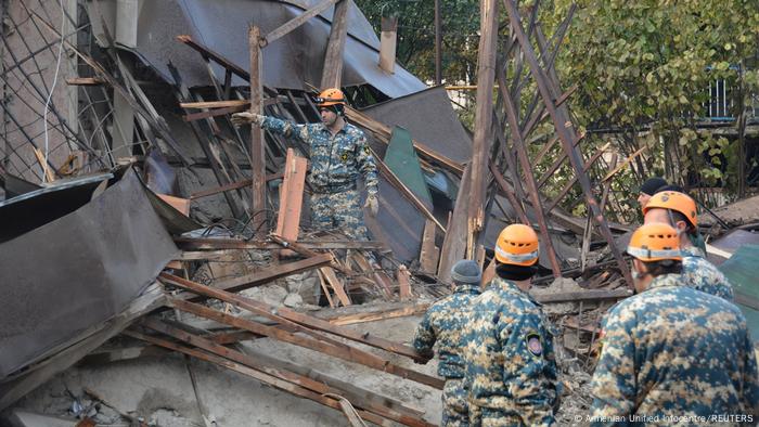 Rescuers visting the site of a shelling