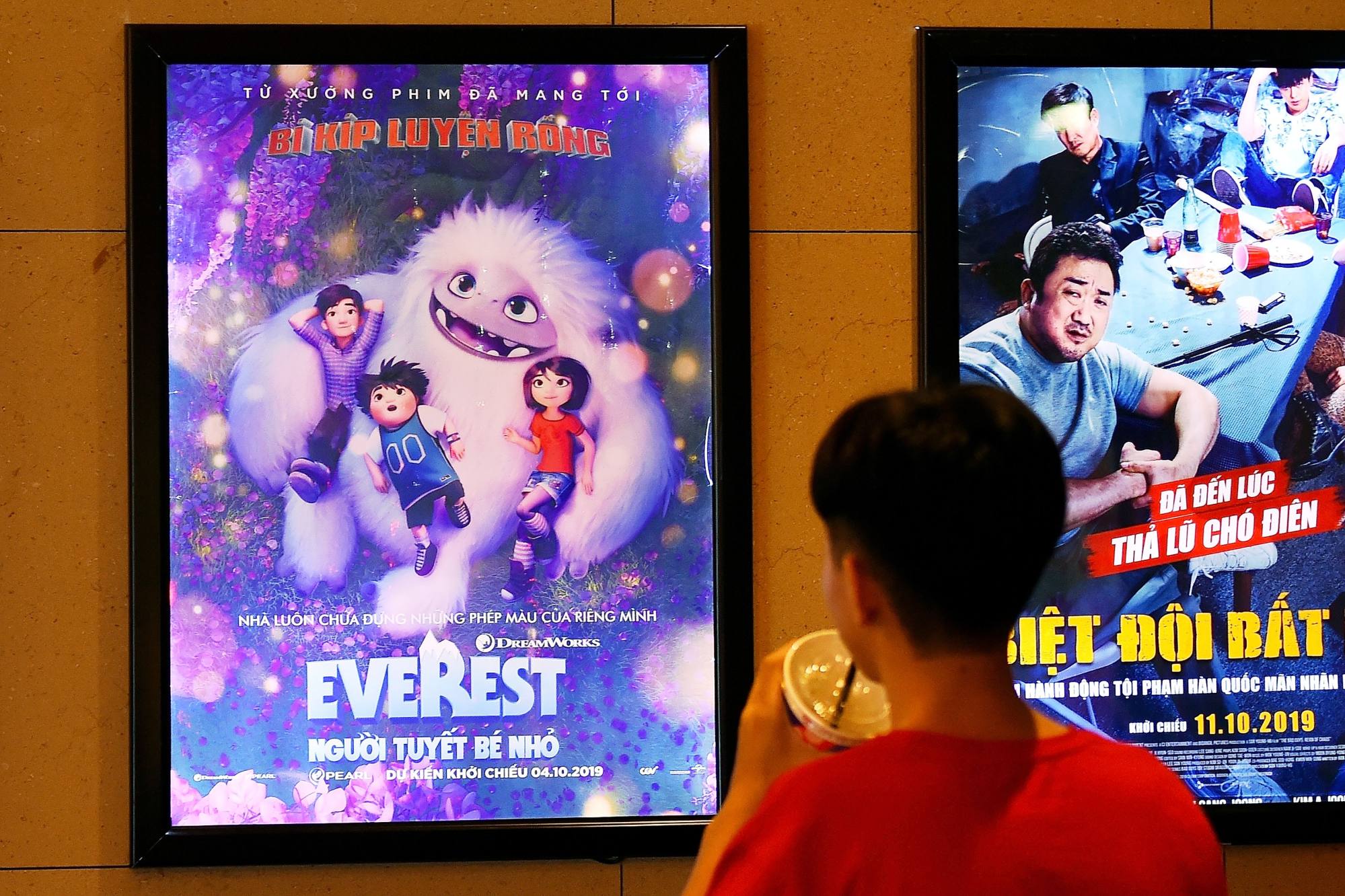 A boy looks at a poster for the animated film Everest Nguoi Tuyet Be Nho, also known as Abominable. Vietnam pulled the film from theatres over a scene featuring China’s claims to the South China Sea on a map. Photo: AFP