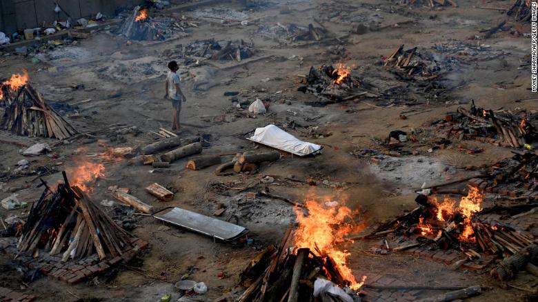 A man stands amid burning pyres of Covid-19 victims at a crematorium in New Delhi, India, on April 26.