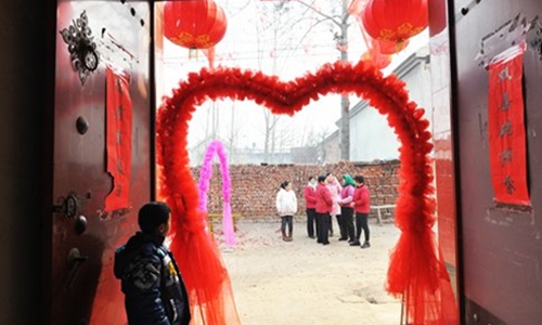 Family members await the start of the wedding in a village in Zouping county, Shandong Province. File Photo: CFP