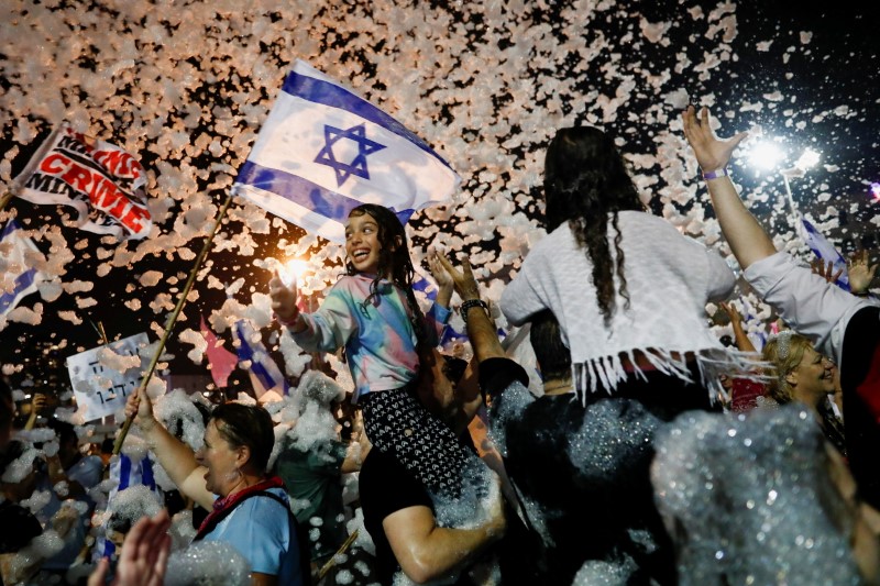 People celebrate after Israel's parliament voted in a new coalition government, ending Benjamin Netanyahu's 12-year hold on power, at Rabin Square in Tel Aviv, Israel June 13, 2021. REUTERS/Corinna Kern