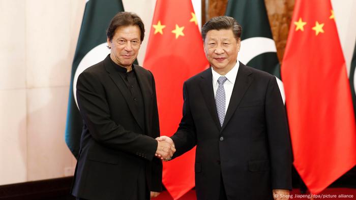 Chinese President Xi Jinping shakes hands with Pakistani Prime Minister Imran Khan in Beijing, in 2019