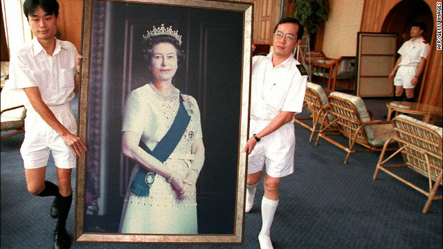 Two Royal Navy sailors carry a portrait of Queen Elizabeth through the British Forces' Hong Kong headquarters as her pictures are taken down ahead of the handover of Hong Kong in 1997.