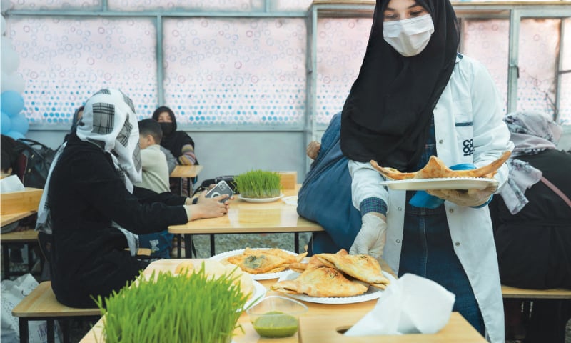 A WAITER delivers samosas to customers at Kabul’s  Banowan-i-Afghan restaurant, which employs female staff.—AFP