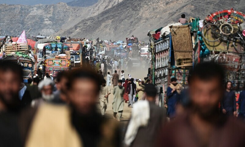 Afghan refugees gather at a makeshift camp upon their arrival from Pakistan, near the Afghanistan-Pakistan Torkham border in Nangarhar province on November 2. — AFP