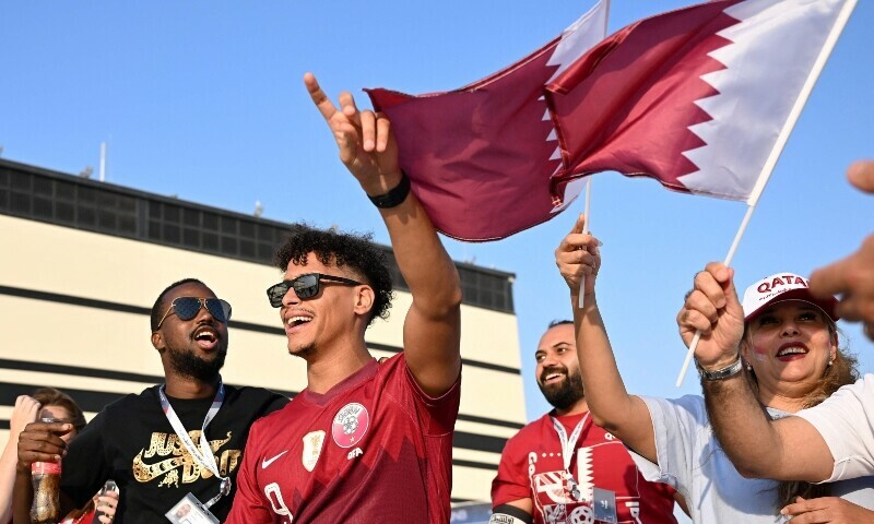 <p>Qatar’s supporters wave a flag as they arrive at the Al-Bayt Stadium in Al Khor, north of Doha, on November 20, 2022, before the kick-off match of the Qatar 2022 World Cup football tournament between Qatar and Ecuador. — AFP</p>