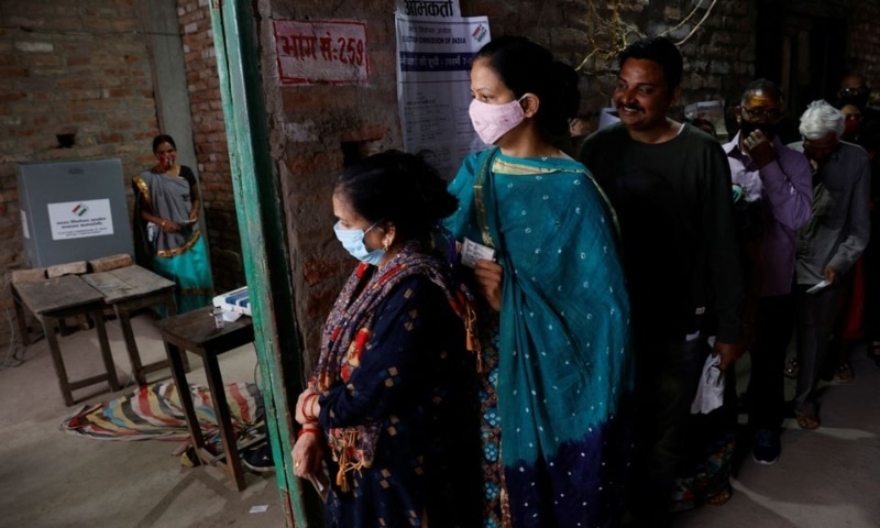 A woman leaves after casting her vote as others wait for their turn at a polling station during the last phase of state assembly election in Varanasi in the northern state of Uttar Pradesh, India, March 7. — Reuters