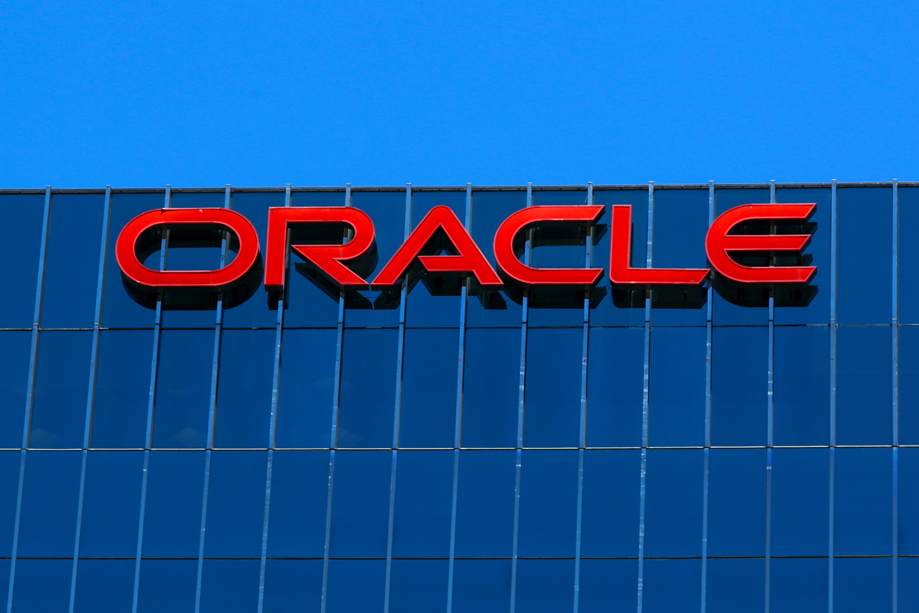 The Oracle logo is shown on an office building in Irvine, California