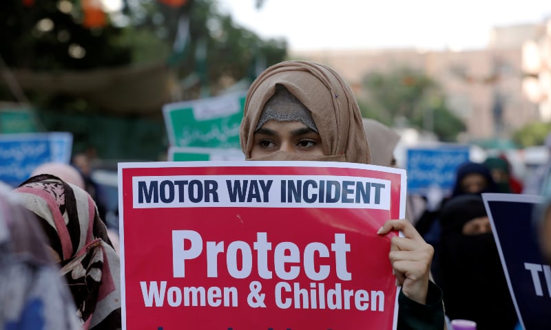 A supporter of Jamaat-i-Islami (JI) carries a sign against the gang-rape that occurred along the motorway near Lahore during a demonstration in Karachi on Friday. — Reuters