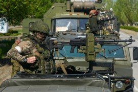 Russian servicemen stand on military vehicles near the Zaporizhzhia nuclear power station, the largest nuclear power plant in Europe and among the 10 largest in the world, in Enerhodar, Zaporizhzhia region, southeastern Ukraine [File: AP Photo]