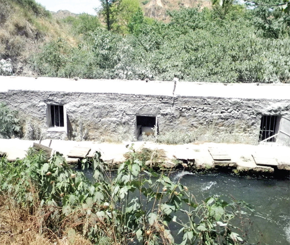 A traditional water mill on a stream in a valley near Hassanabdal.