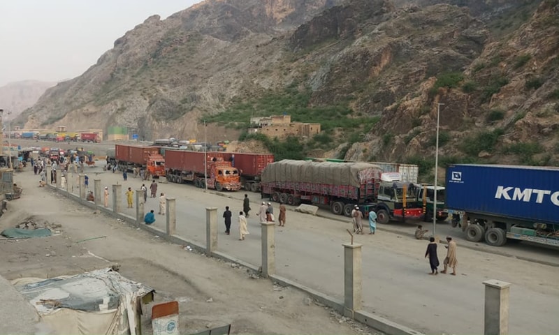 GOODS transporters await the reopening of the Torkham border in Khyber, on Tuesday.—Photo by the writer