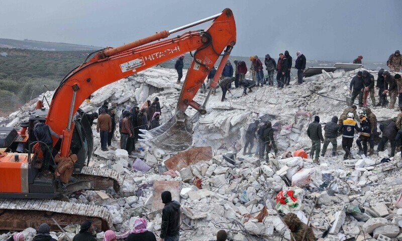 Residents and rescuers search for victims and survivors amidst the rubble of collapsed buildings following an earthquake in the village of Besnaya in Syria’s rebel-held northwestern Idlib province on the border with Turkiye, on February 6, 2022. — AFP