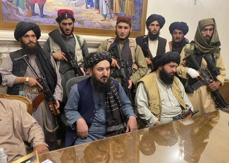 Taliban fighters take control of Afghan presidential palace after the Afghan President Ashraf Ghani fled the country, in Kabul, Afghanistan, Sunday, Aug. 15, 2021. (AP Photo/Zabi Karimi)