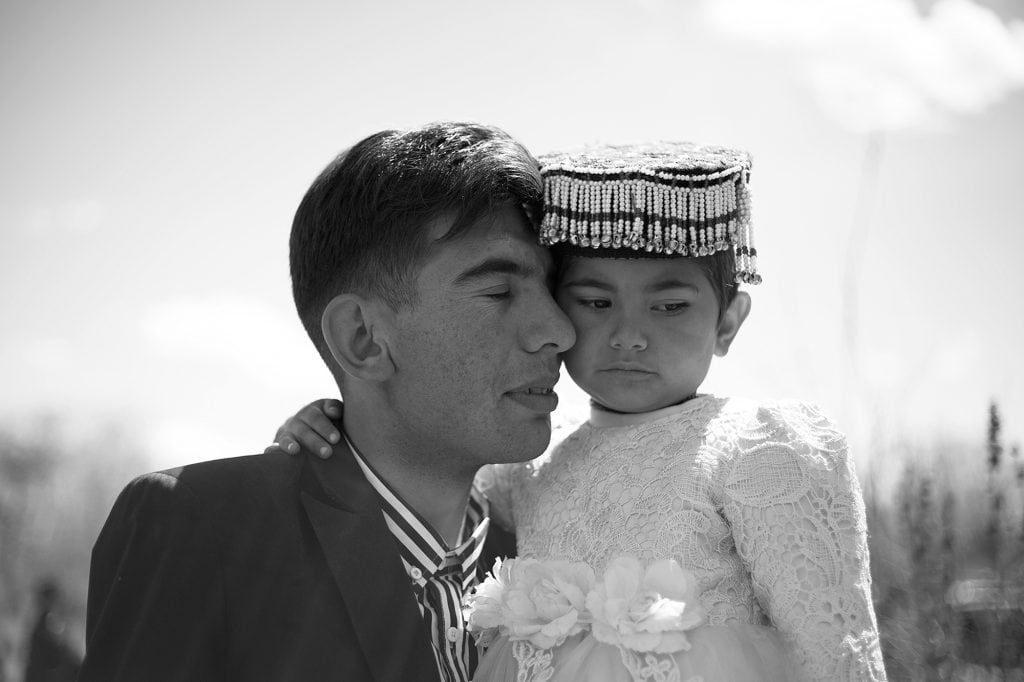 A-man-carries-his-daughter-Xinjiang-1024x682.jpg