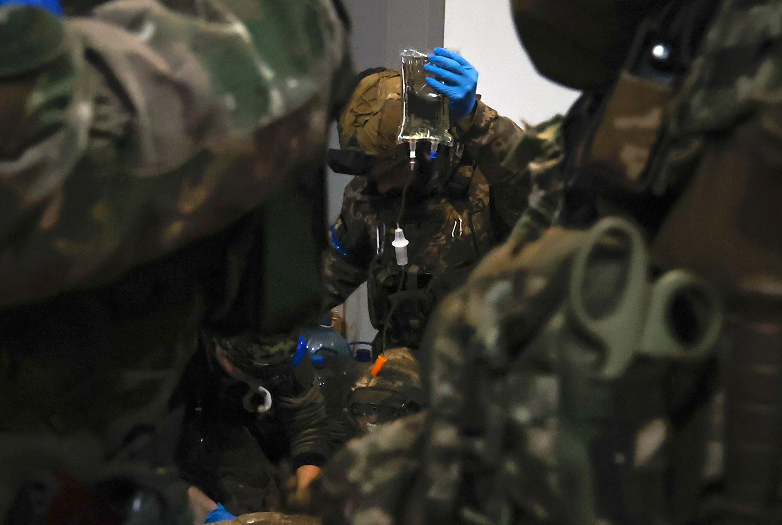 A Ukrainian serviceman administers first aid to a wounded soldier at a shelter in Soledar on January 8.