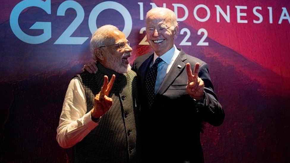 President Joe Biden (R) gestures with India's Prime Minister Narendra Modi as the two leaders met in a hallway as Biden was going to a European Commission on the Partnership for Global Infrastructure and Investment on the sidelines of the G20 Summit in Nusa Dua, on the Indonesian island of Bali, on November 15, 2022.