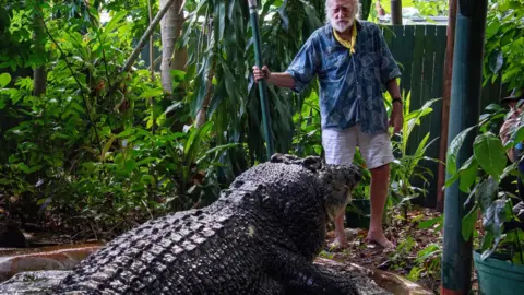 EPA Green Island Marineland Melanesia's George Craig stands with Cassius the crocodile at the Marineland Melanesia on Green Island, Queensland, Australia, 18 March 2023