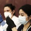 A pharmacist volunteer prepares doses of the Johnson and Johnson coronavirus vaccine during a pop-up clinic in Detroit, Michigan.