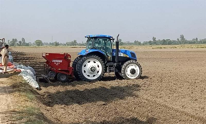 A mulcher is attached to a tractor to mix stubble into the soil. It is an alternative for disposing of stubble without burning — Photo by Tahir Wattoo/File