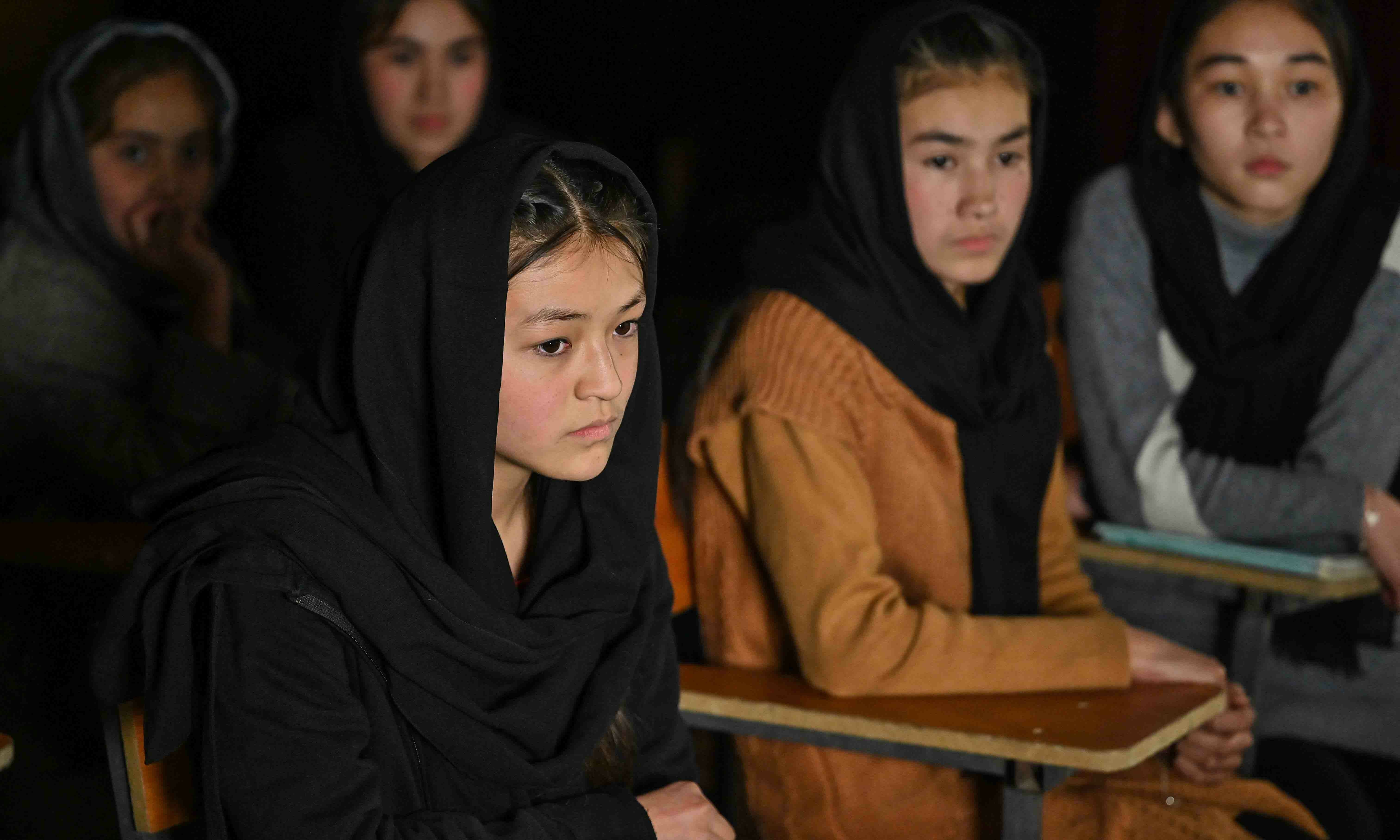 This picture taken on November 28 shows student Mursal (L) and others attending a class on-air at Radio Begum in Kabul. — AFP