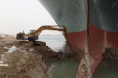 The 59-metre wide vessel is lodged sideways and impeding all traffic across the waterway of Egypt's Suez Canal [AFP]