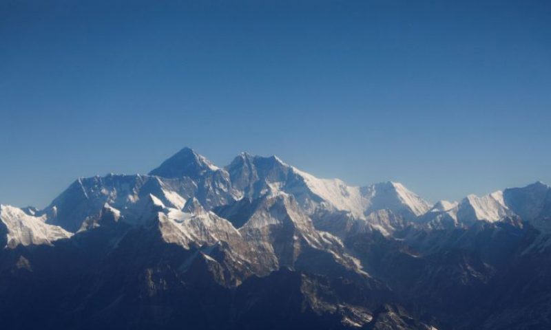 Mount Everest, the world's highest peak, and other peaks of the Himalayan range are seen through an aircraft window. in this file photo. — Reuters